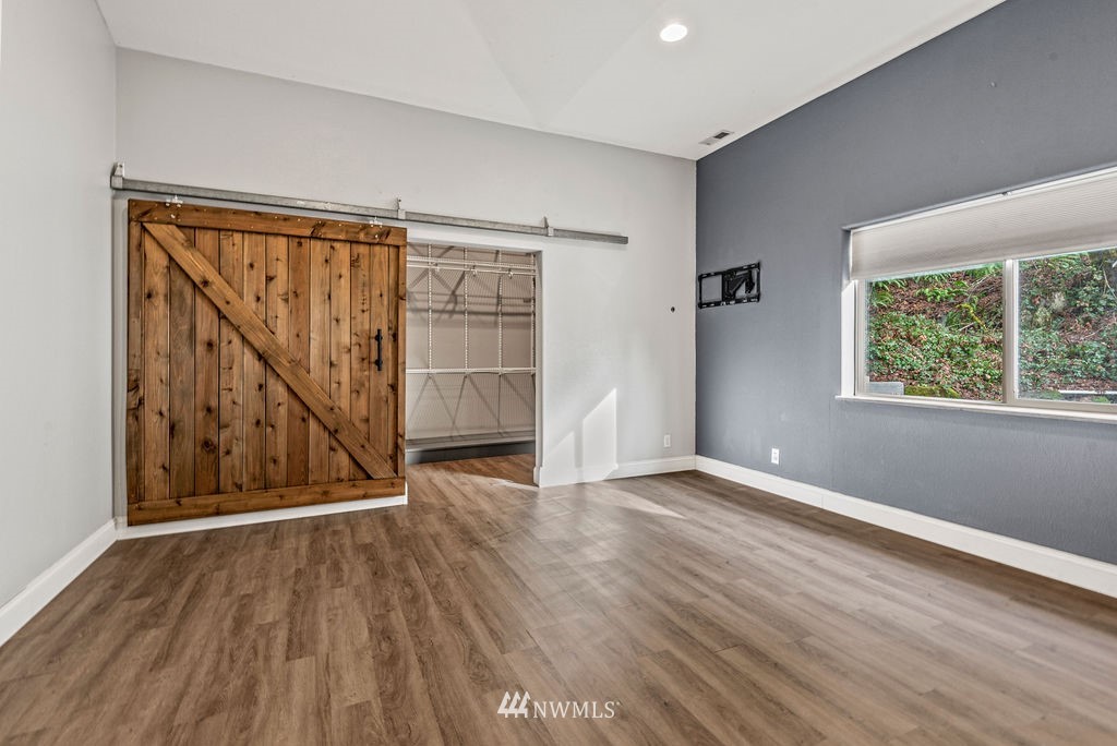195 Puma Road Longview, WA 98632 - Photo 16 of 39 an empty room with wooden floor and windows