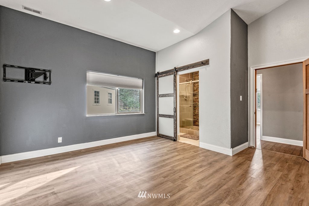 195 Puma Road Longview, WA 98632 - Photo 19 of 39 an empty room with wooden floor and windows
