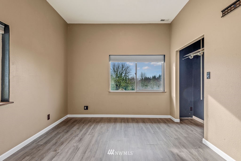 195 Puma Road Longview, WA 98632 - Photo 22 of 39 a view of an empty room with wooden floor and a window