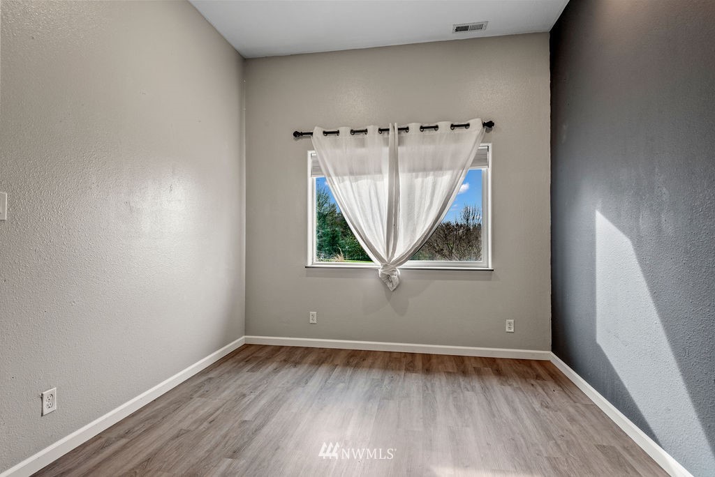 195 Puma Road Longview, WA 98632 - Photo 25 of 39 an empty room with a window and wooden floor