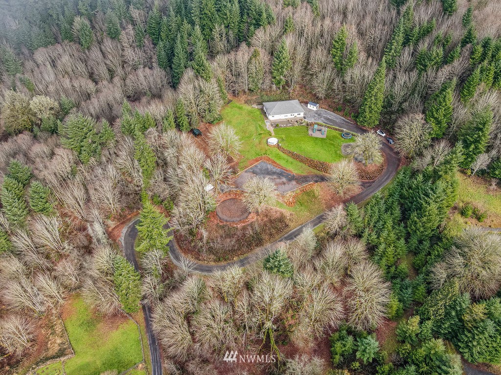 195 Puma Road Longview, WA 98632 - Photo 29 of 39 a view of a swimming pool with a yard and large trees