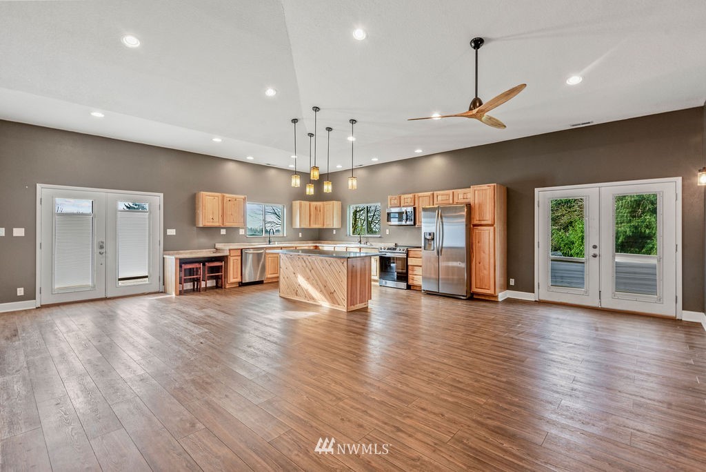 195 Puma Road Longview, WA 98632 - Photo 6 of 39 an open kitchen with stainless steel appliances granite countertop a stove top oven a refrigerator and wooden floor