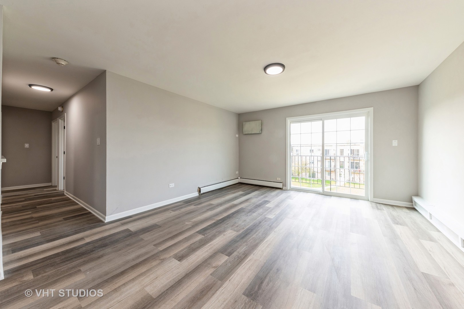159 West Elk Trail, Unit 356 Carol Stream, IL 60188 - Photo 2 of 21 a view of an empty room with wooden floor and a window