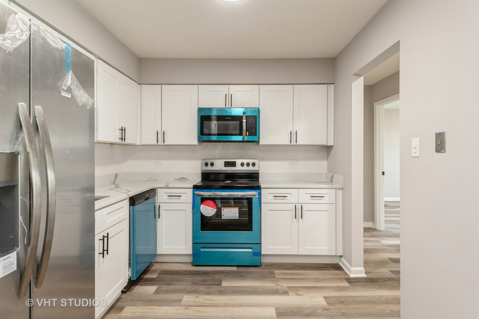159 West Elk Trail, Unit 356 Carol Stream, IL 60188 - Photo 4 of 21 a kitchen with white cabinets and stainless steel appliances
