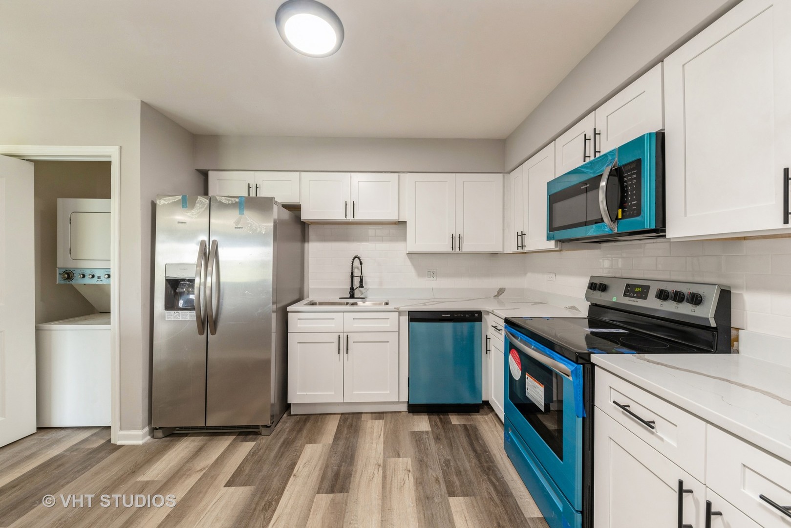 159 West Elk Trail, Unit 356 Carol Stream, IL 60188 - Photo 5 of 21 a kitchen with stainless steel appliances granite countertop a stove a sink and a refrigerator