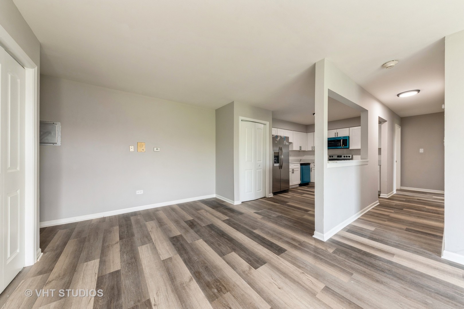 159 West Elk Trail, Unit 356 Carol Stream, IL 60188 - Photo 7 of 21 a view of a kitchen with wooden floor and a refrigerator