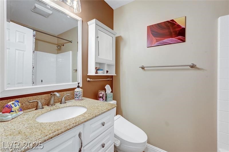 2410 Doherty Way Henderson, NV 89014 - Photo 32 of 63 Full bathroom with toilet, vanity, and a shower