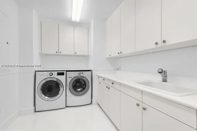a utility room with sink dryer and washer