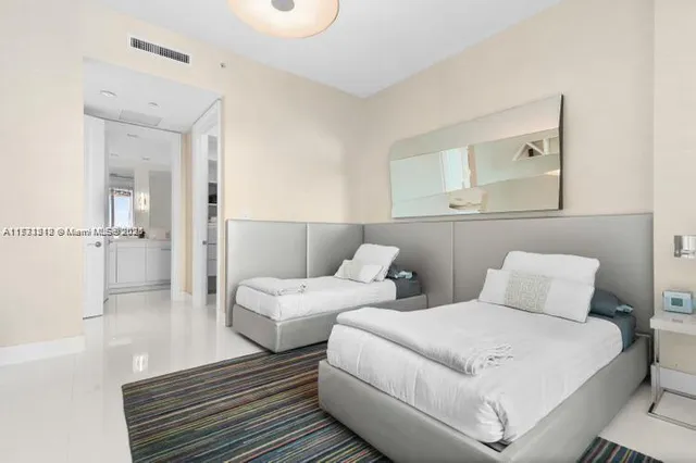 a bedroom with a bed and a painting on the wall