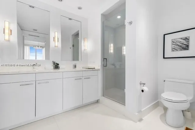 a bathroom with a toilet sink and shower