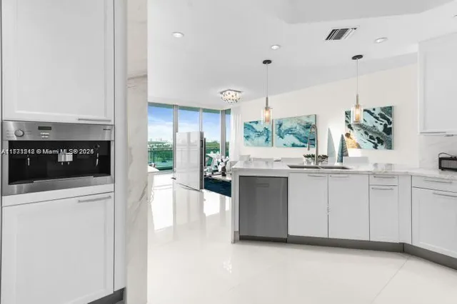 a kitchen with kitchen island granite countertop a stove a sink and a refrigerator