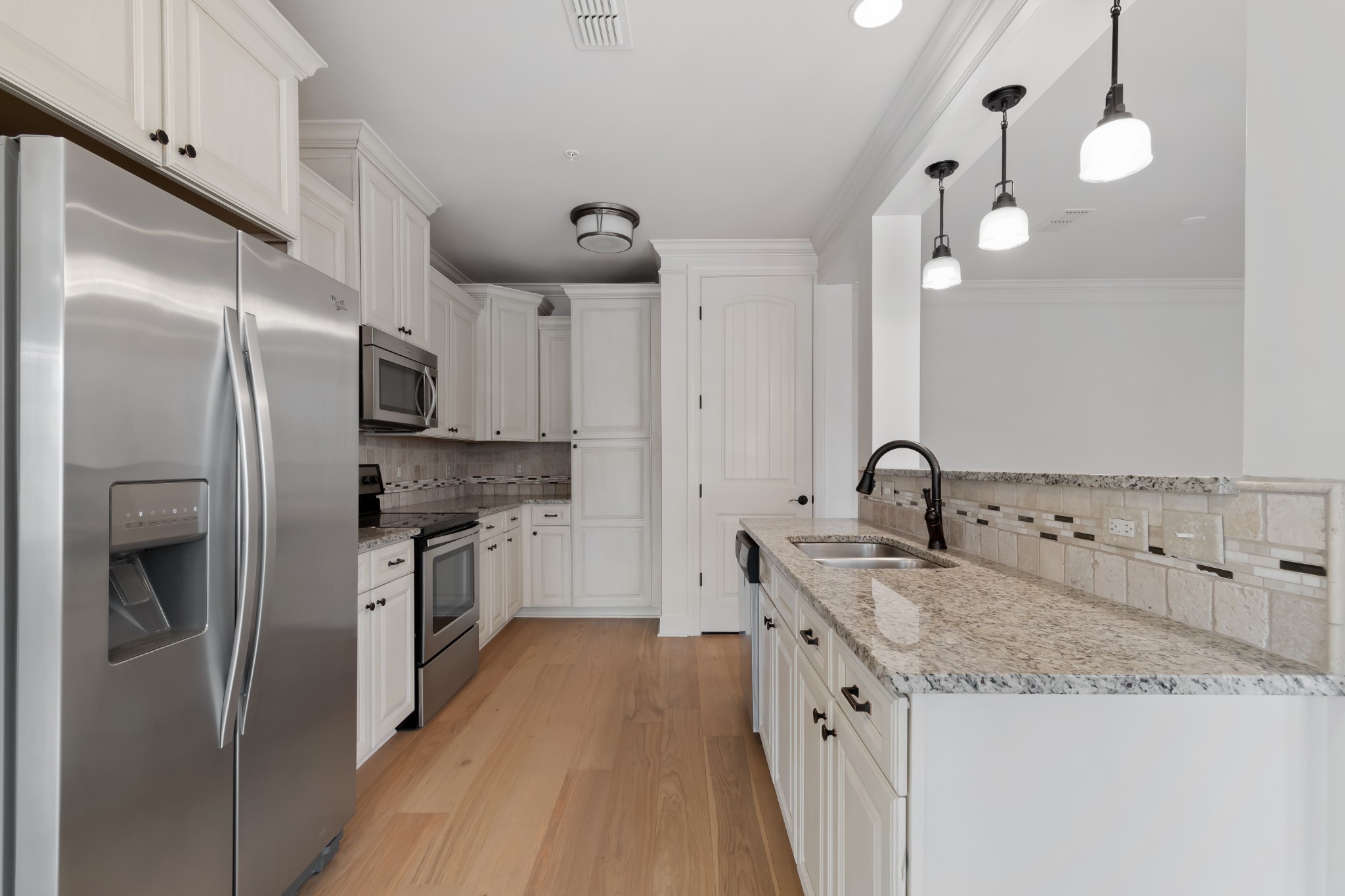 106 Front Street, Unit 23 Franklin, TN 37064 - Photo 24 of 39 a kitchen with stainless steel appliances granite countertop a sink a stove and a refrigerator