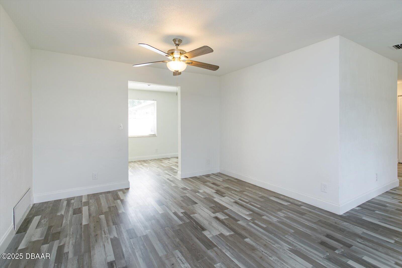 4319 South Peninsula Drive Ponce Inlet, FL 32127 - Photo 11 of 30 a view of empty room with wooden floor and fan