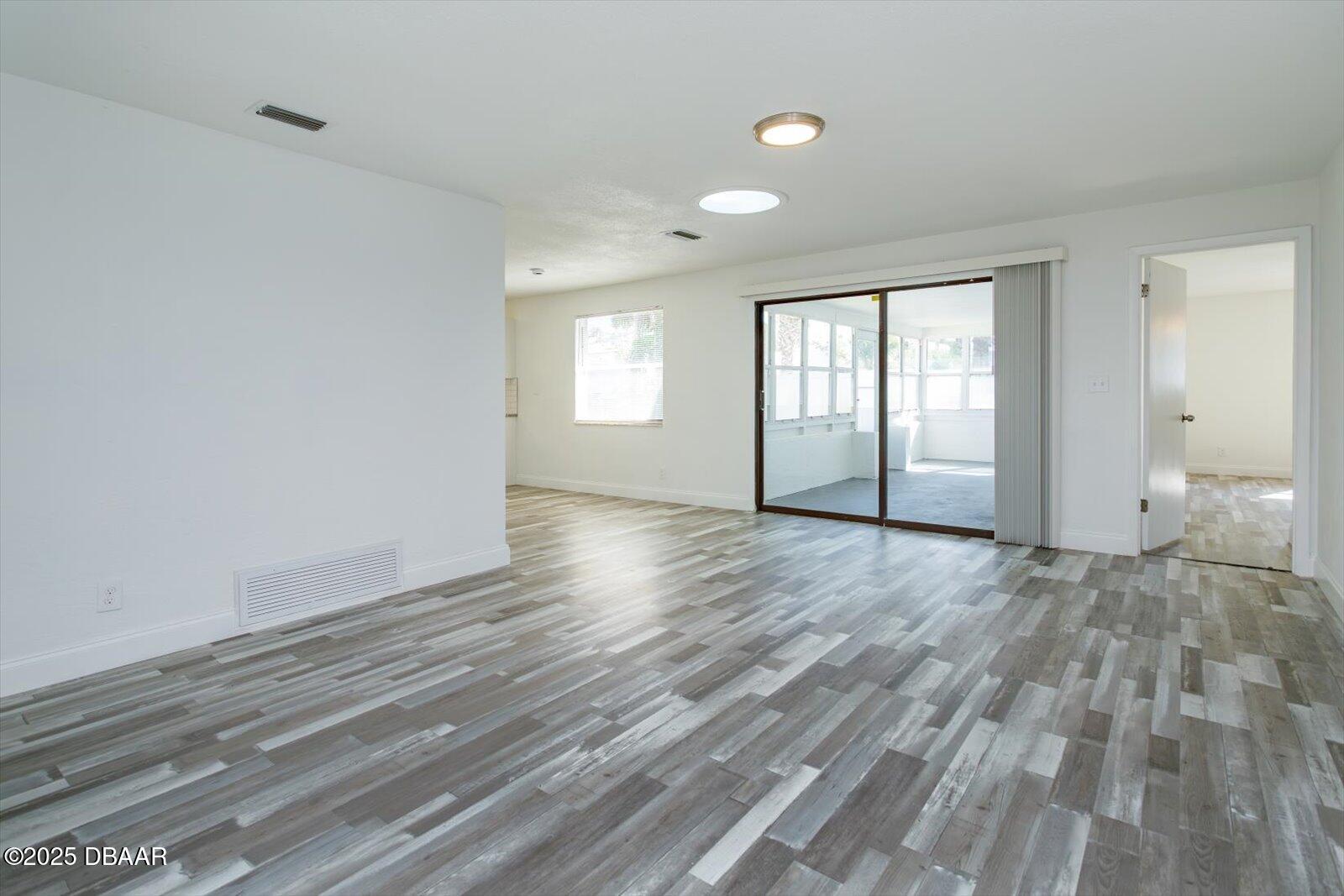 4319 South Peninsula Drive Ponce Inlet, FL 32127 - Photo 12 of 30 a view of empty room with wooden floor and fan
