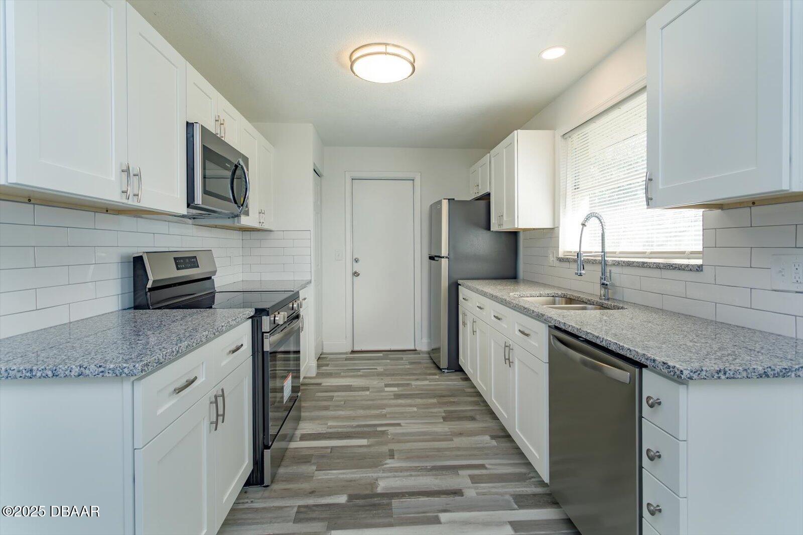 4319 South Peninsula Drive Ponce Inlet, FL 32127 - Photo 15 of 30 a large kitchen with stainless steel appliances granite countertop a sink stove and refrigerator