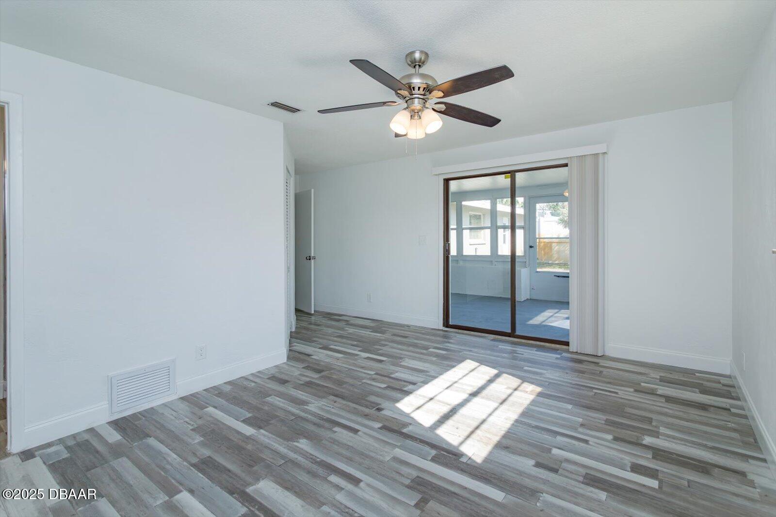 4319 South Peninsula Drive Ponce Inlet, FL 32127 - Photo 21 of 30 a view of empty room with wooden floor and fan