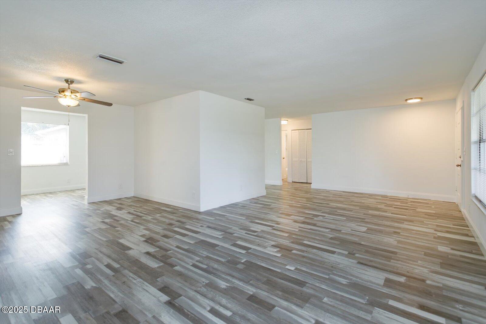 4319 South Peninsula Drive Ponce Inlet, FL 32127 - Photo 9 of 30 a view of empty room with wooden floor and fan