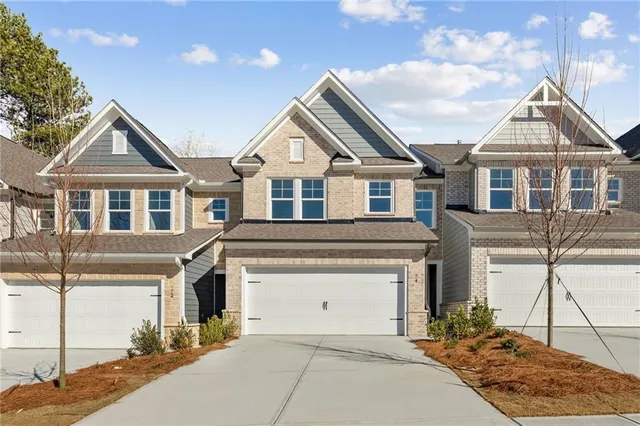 a front view of a house with a yard