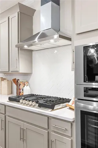 a stove top oven sitting inside of a kitchen