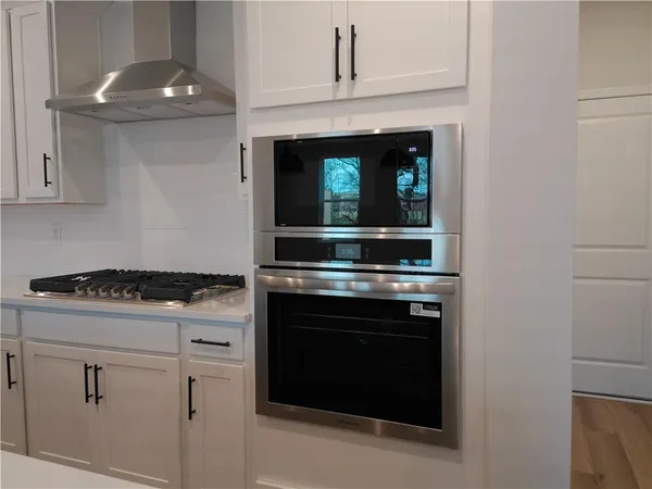 a stove top oven sitting inside of a kitchen