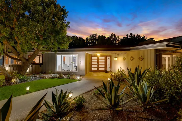 a living room with furniture large window and a fireplace