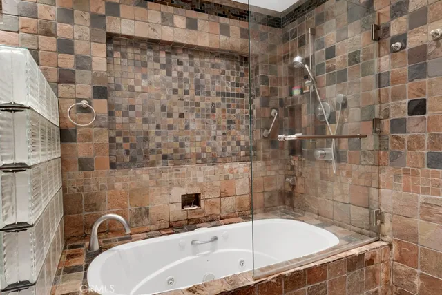 a kitchen with stainless steel appliances kitchen island granite countertop a stove and a sink