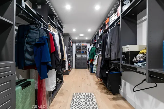a kitchen with stainless steel appliances granite countertop a dining table chairs and white cabinets