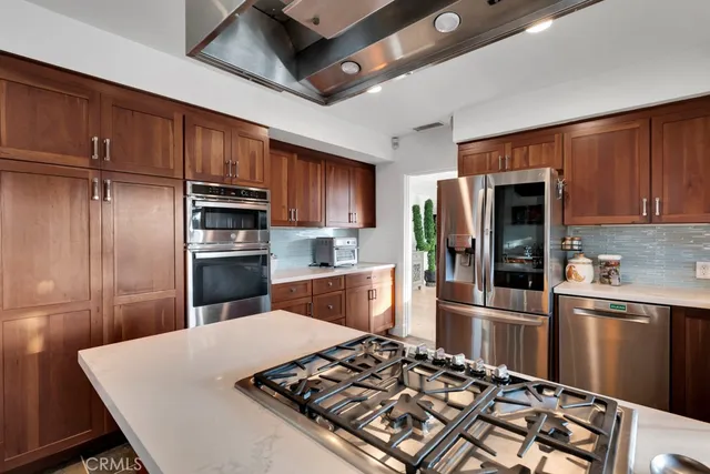 a view of a patio with table and chairs and potted plants