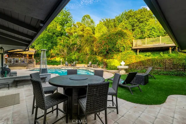 a view of a patio with table and chairs and potted plants