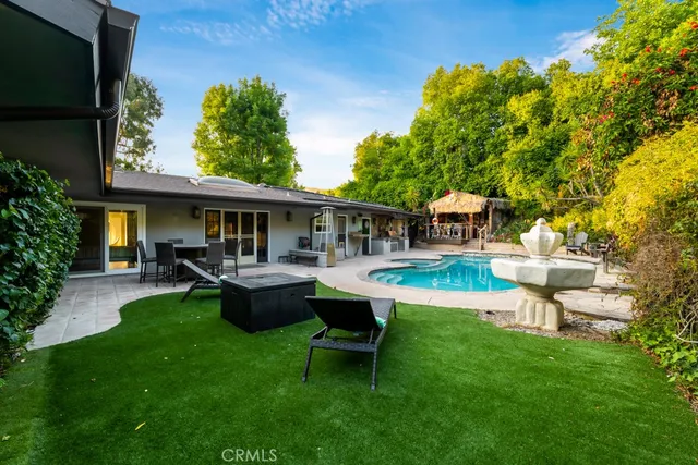 a view of a swimming pool with two chairs and a table