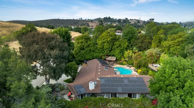 a front view of house with yard outdoor seating and barbeque oven