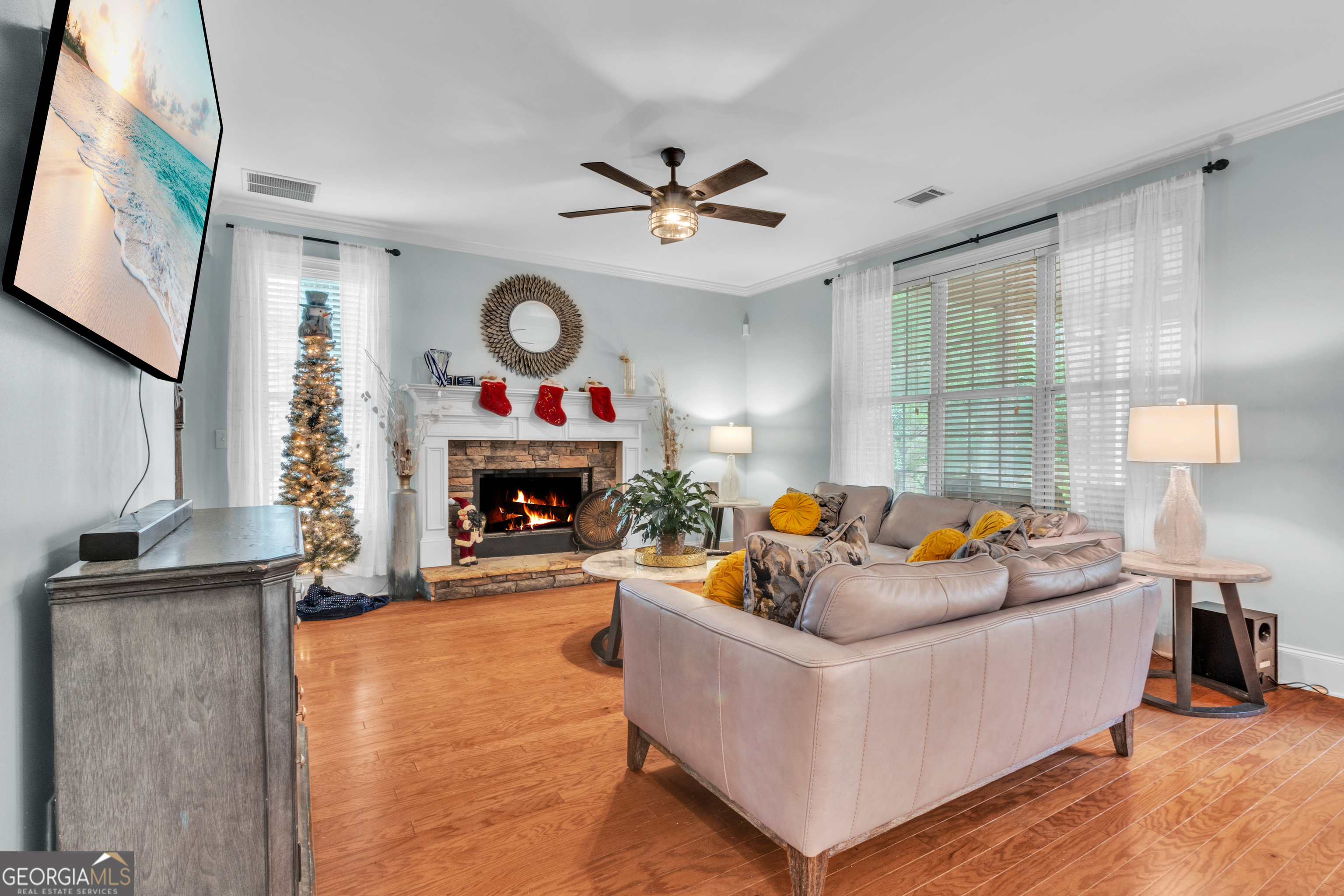 111 Caraway Road Locust Grove, GA 30248 - Photo 16 of 52 a living room with furniture a fireplace and a large window