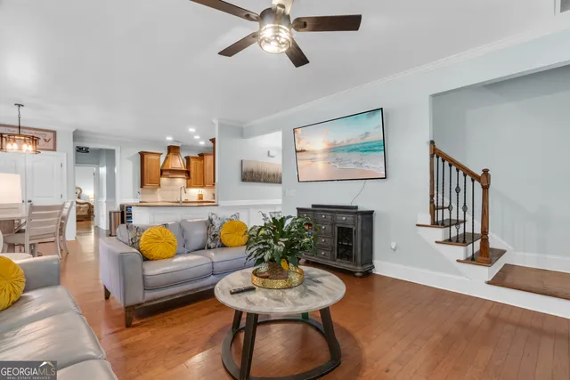 a living room with furniture kitchen and a window