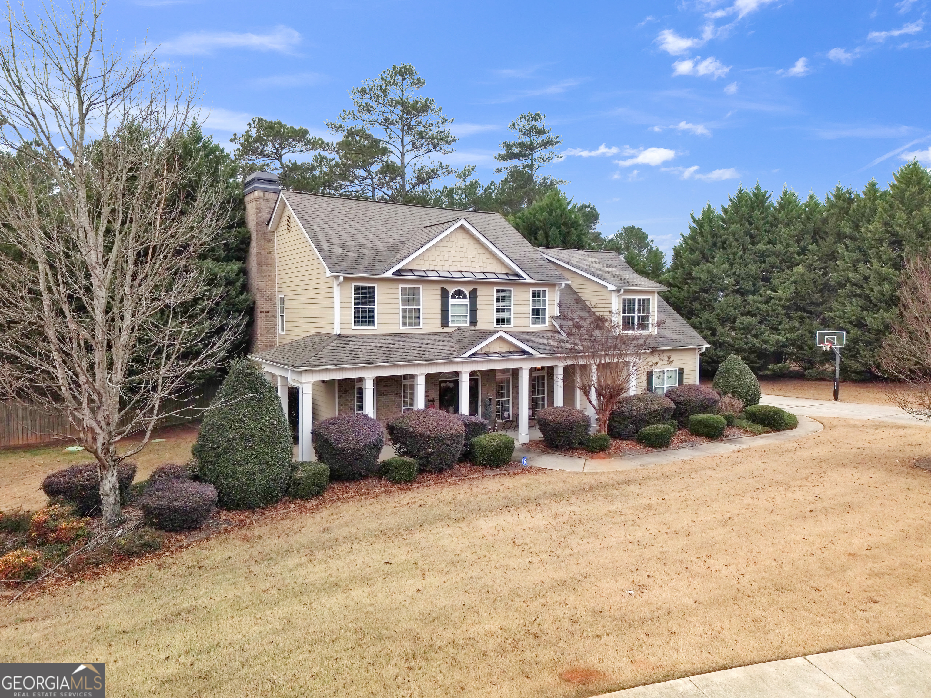 111 Caraway Road Locust Grove, GA 30248 - Photo 2 of 52 a front view of a house with a yard covered with snow and trees