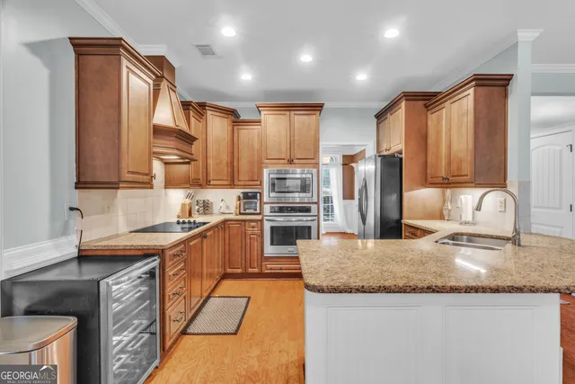 a kitchen with granite countertop cabinets stainless steel appliances and a sink