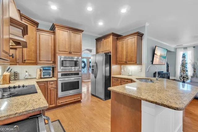 a kitchen with cabinets stainless steel appliances and a window