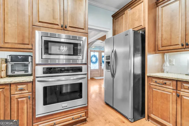 a kitchen with granite countertop a sink and cabinets