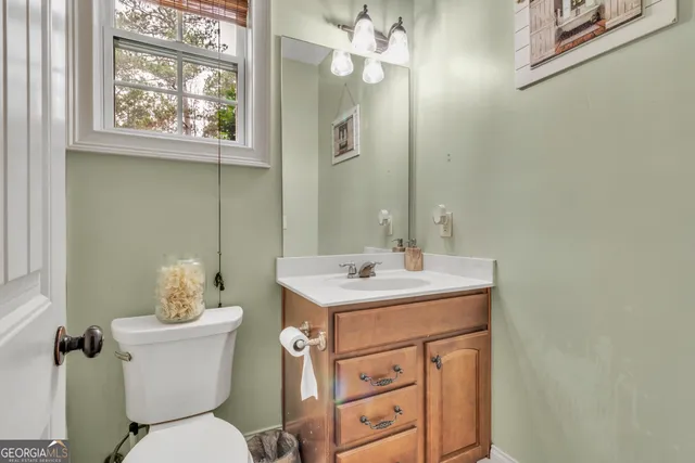 a bedroom with a bed and a flat tv screen on dresser