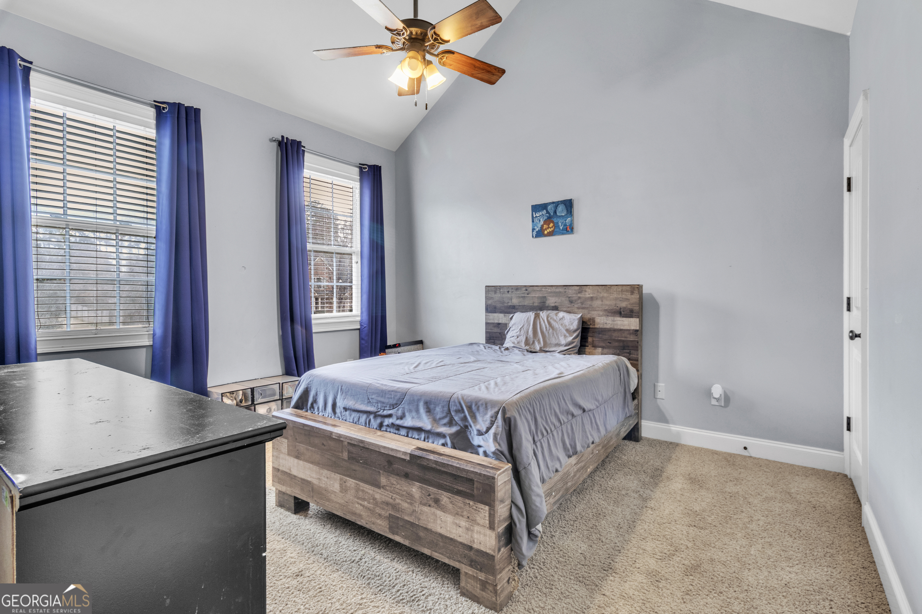 111 Caraway Road Locust Grove, GA 30248 - Photo 33 of 52 a bedroom with a bed and a chandelier