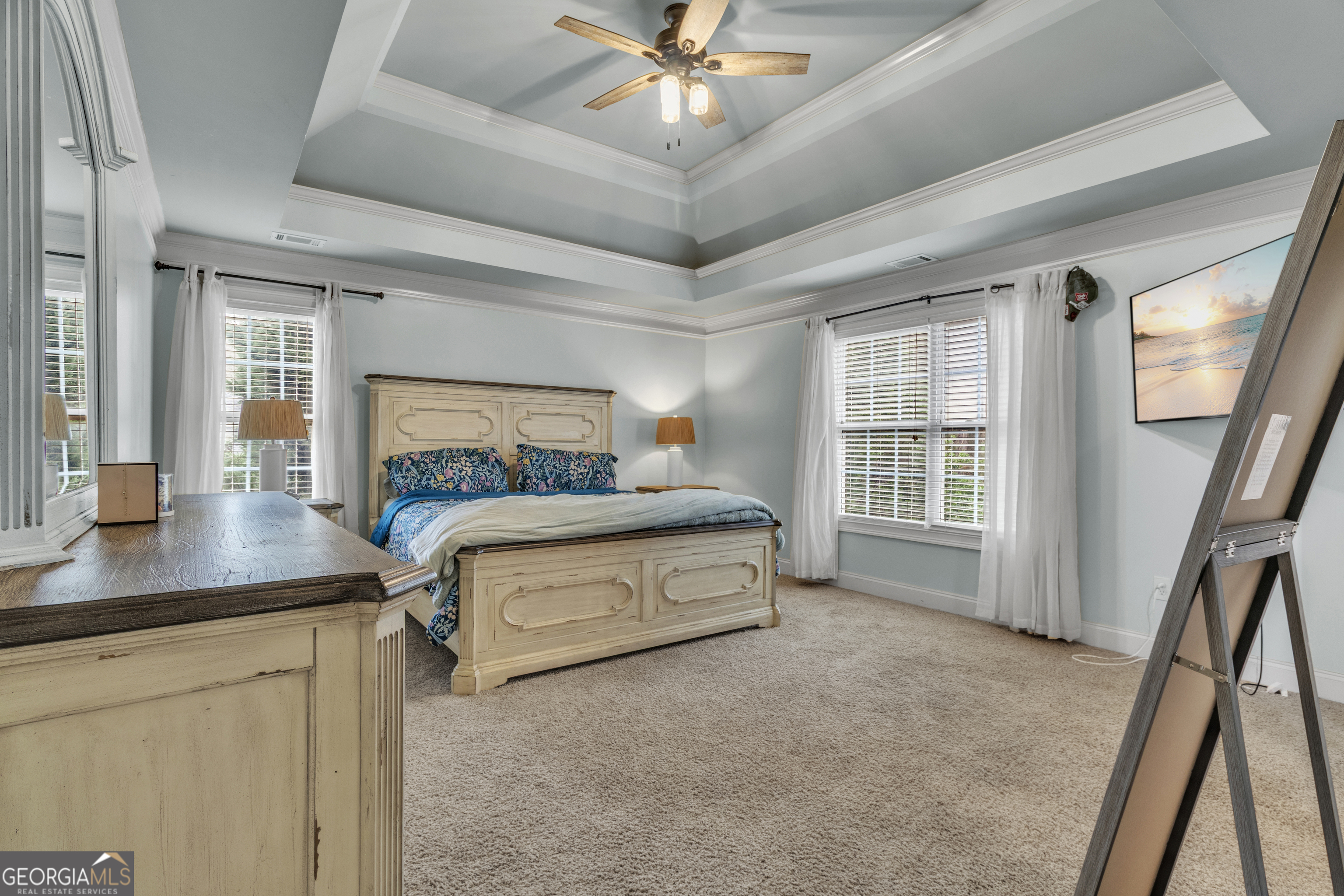 111 Caraway Road Locust Grove, GA 30248 - Photo 34 of 52 a spacious bedroom with a bed and a chandelier