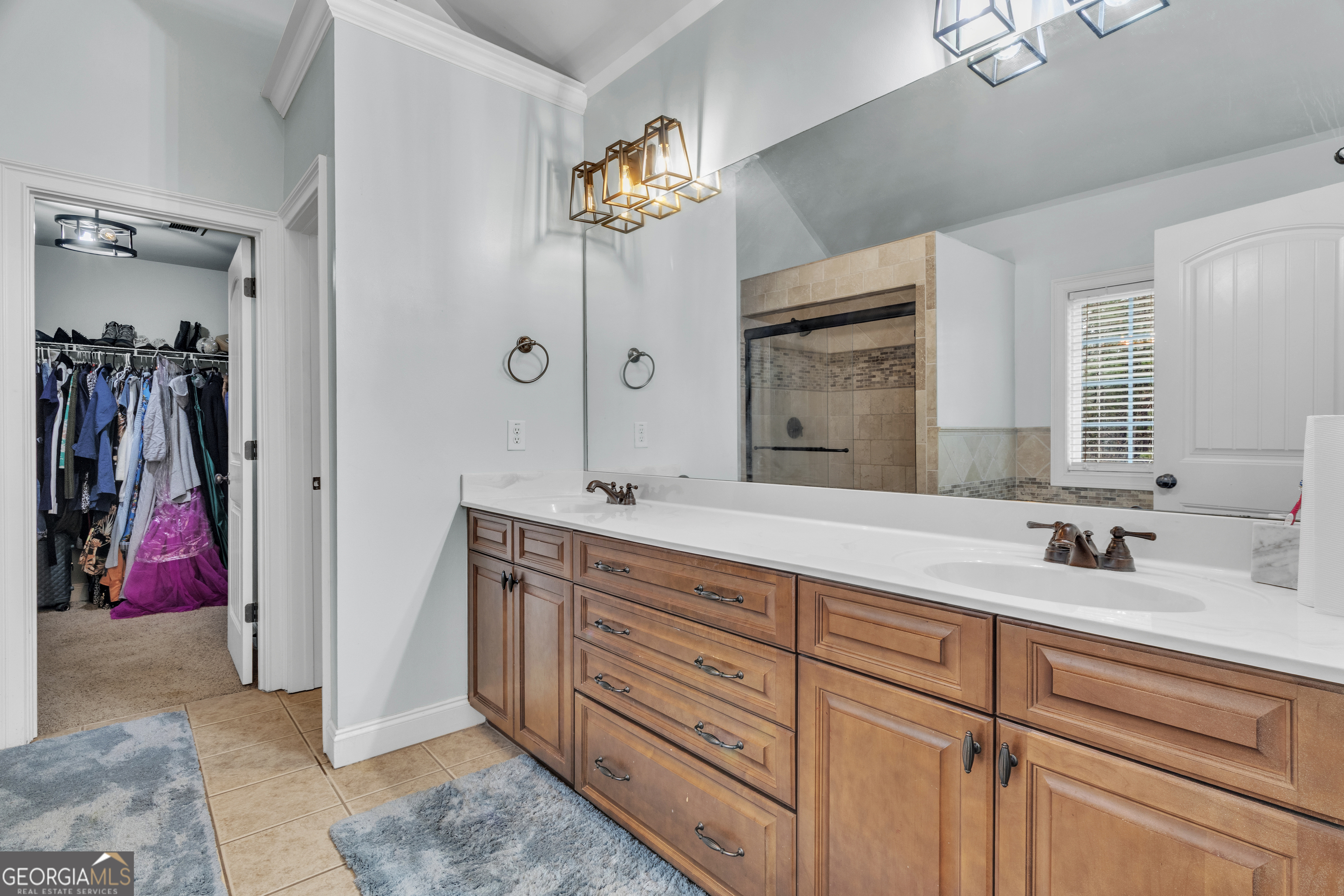 111 Caraway Road Locust Grove, GA 30248 - Photo 36 of 52 a spacious bathroom with a double vanity sink and a mirror