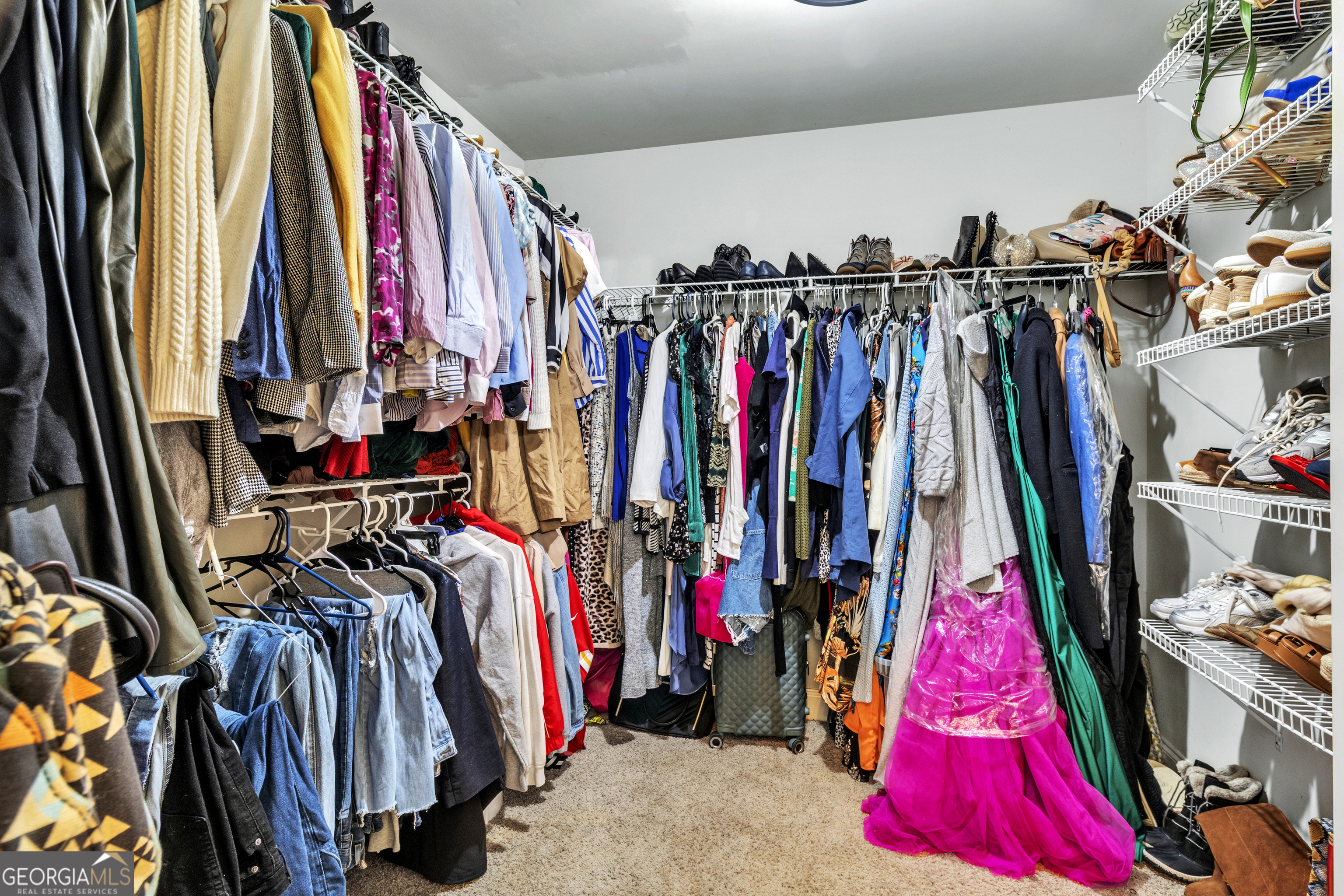 111 Caraway Road Locust Grove, GA 30248 - Photo 37 of 52 a view of walk in closet with clothes
