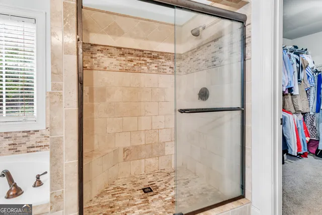 a bathroom with a bathtub and a shower