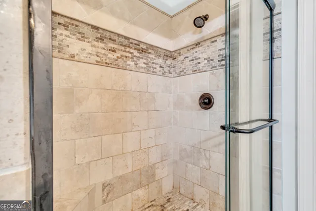 a bathroom with a sink toilet double vanity and shower