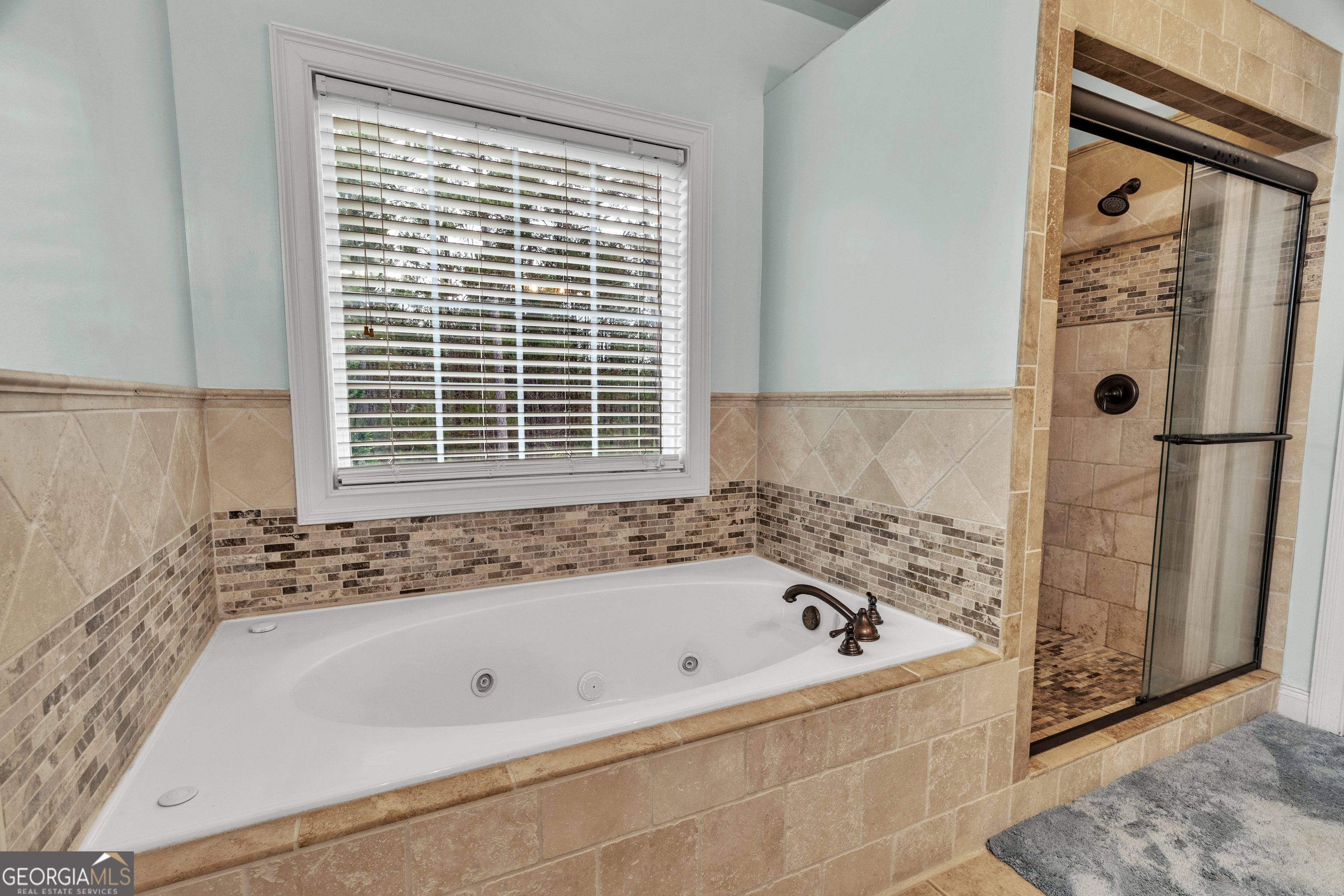 111 Caraway Road Locust Grove, GA 30248 - Photo 40 of 52 a bathroom with a bathtub and a shower