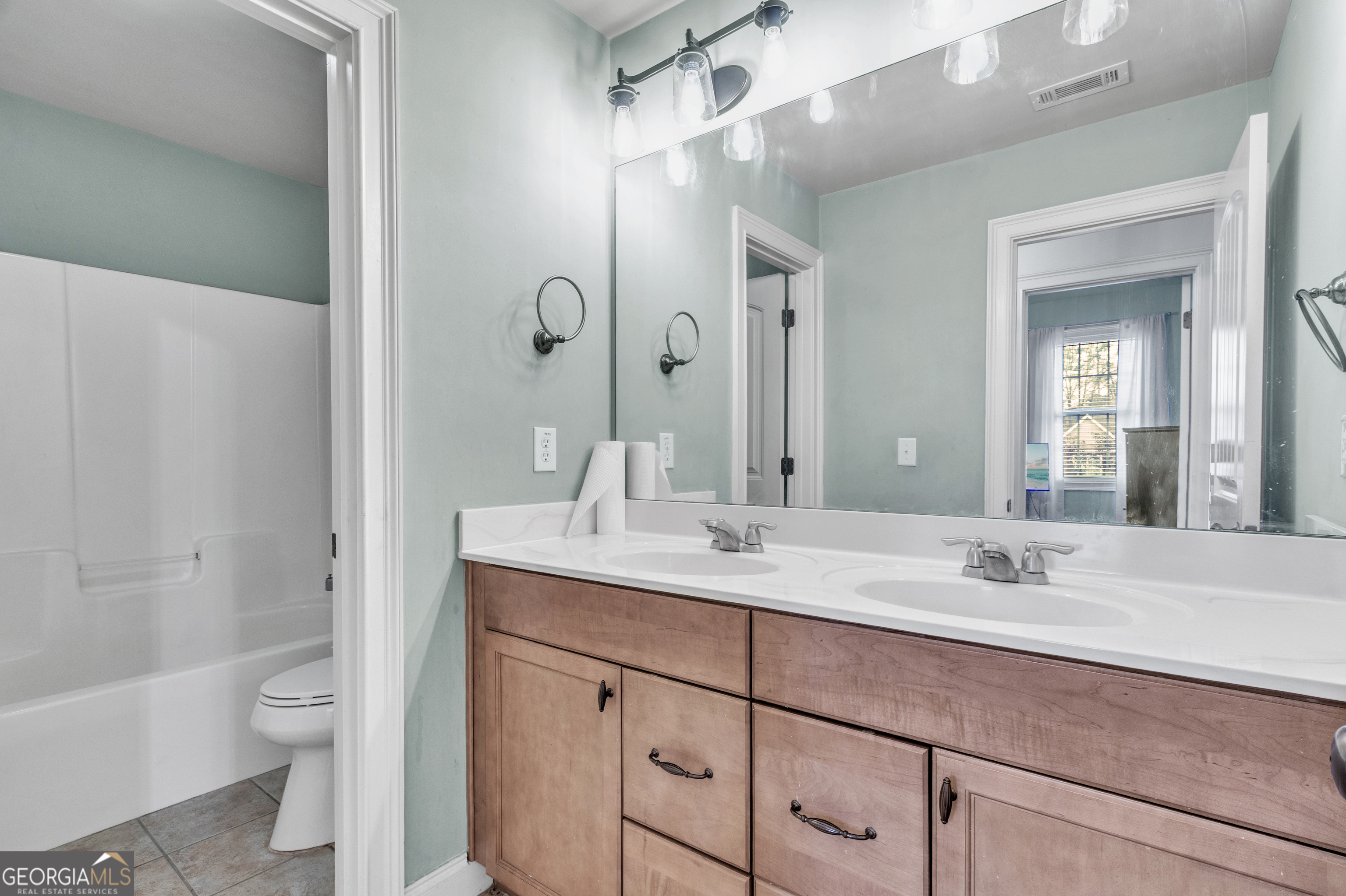 111 Caraway Road Locust Grove, GA 30248 - Photo 41 of 52 a bathroom with a sink toilet double vanity and shower