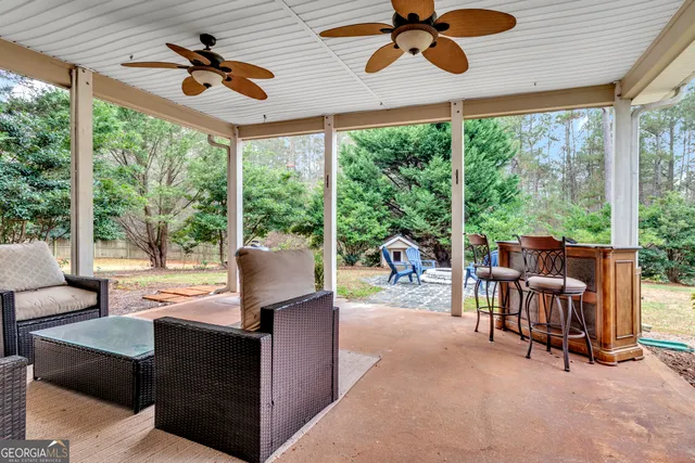 a dining hall with couches a flat screen tv and fireplace