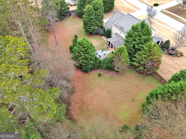 an aerial view of a house with yard