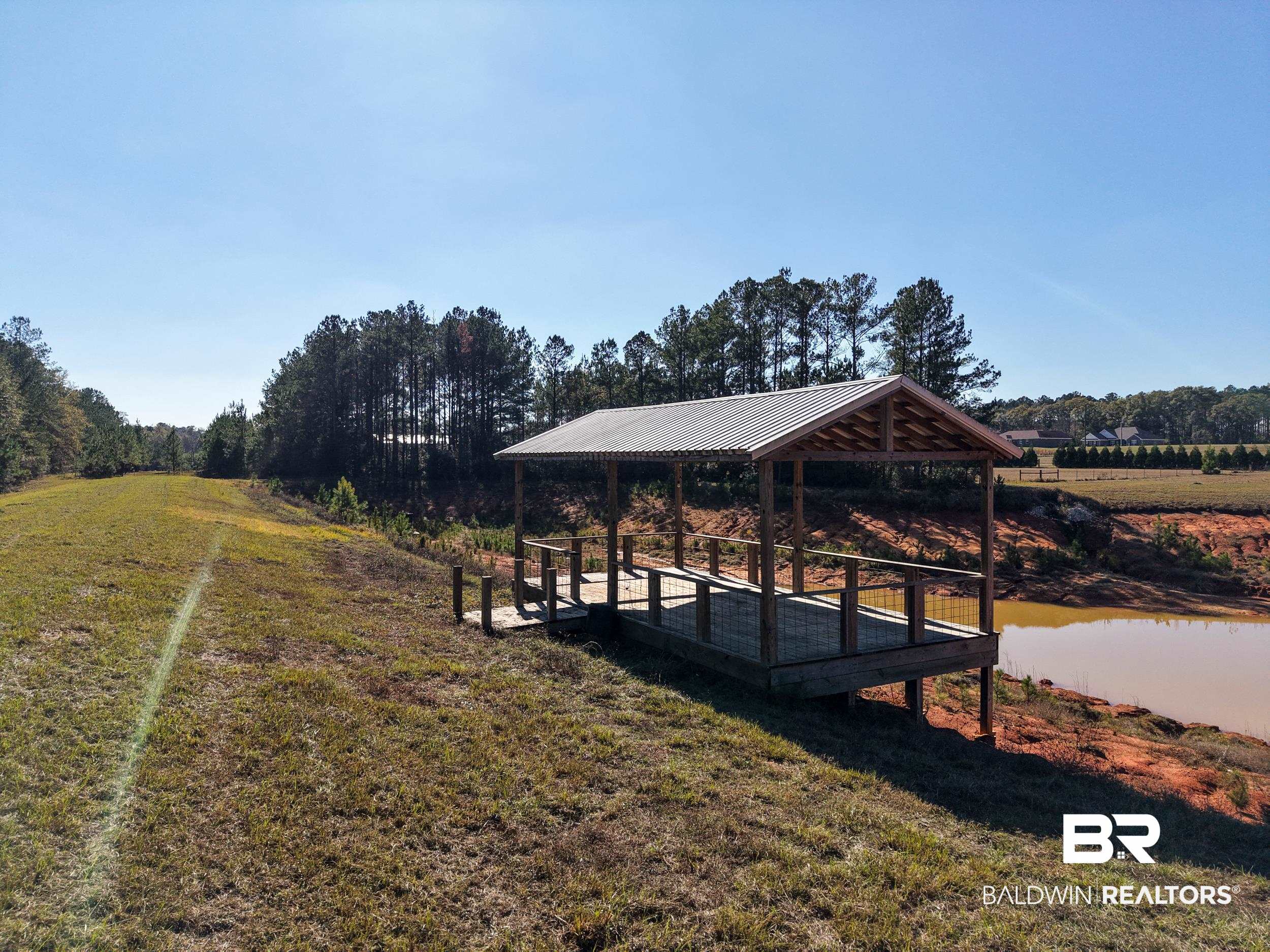 0 Stokley Court Atmore, AL 36502 - Photo 11 of 22 Surrounding community with a yard, a deck, and a view of countryside