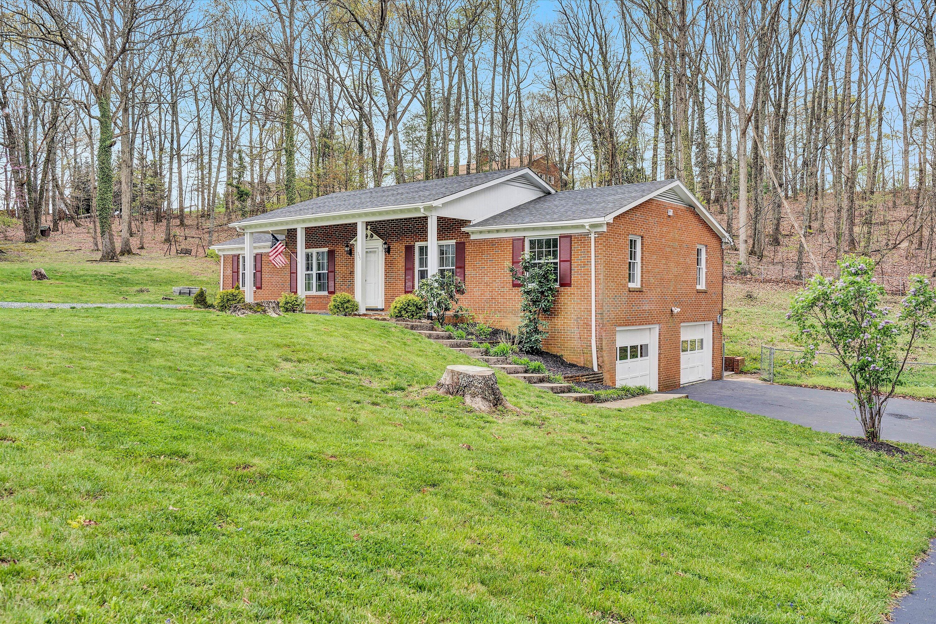 355 Pin Oak Drive Blue Ridge, VA 24064 - Photo 1 of 33 a view of a house with a yard and sitting area